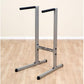 Body-Solid dip station with gray aluminum frame, black handles, and stabilizing feet on wooden floor