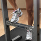 White, gray and pink mesh running shoe with white laces worn by model on Body-Solid dip station, shown in gym setting
