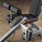 Body-Solid leg extension and curl machine with black padded seat, dual cylindrical leg rollers, silver frame, red adjustment 