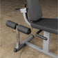 Body-Solid Cam Series leg extension and curl machine with white frame, black padded seat and backrest, dual black cylinders, 