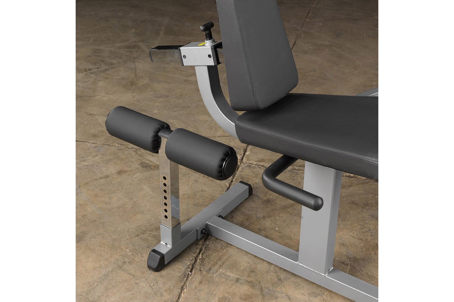 Body-Solid Cam Series leg extension and curl machine with white frame, black padded seat and backrest, dual black cylinders, 