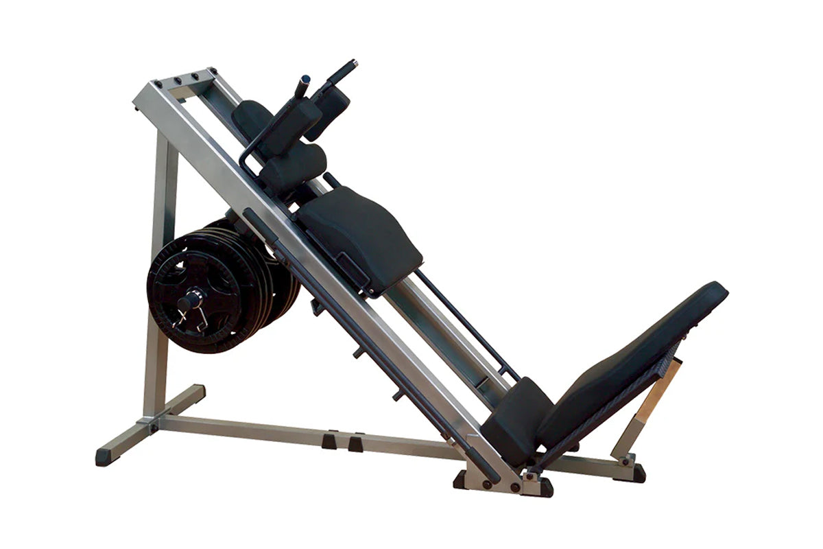 Body-Solid leg press and hack squat machine with silver frame, black foot platform, seat, and weight plate storage on white b