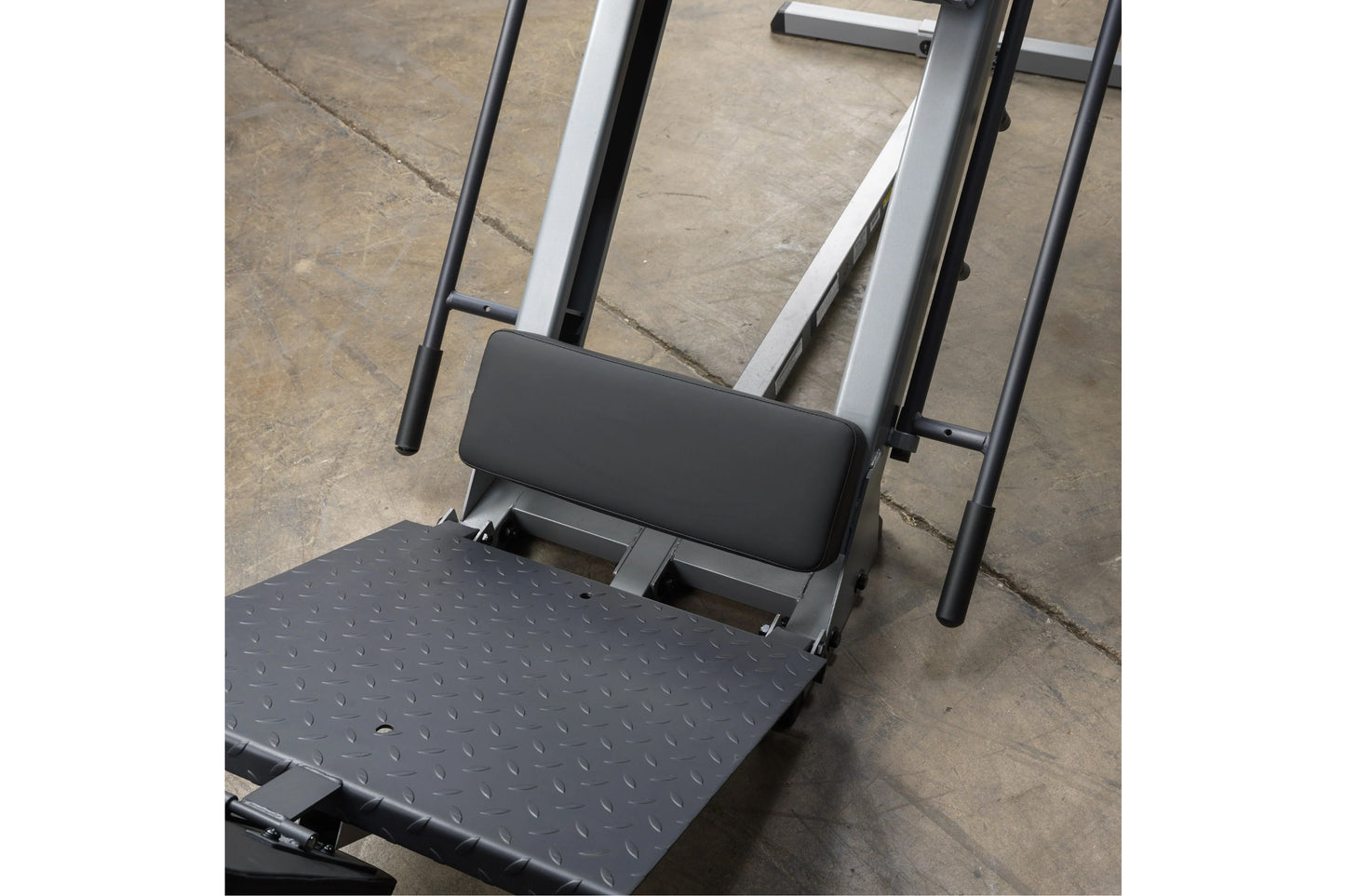 Body-Solid leg press and hack squat machine with black textured platform, padded backrest, and silver and black metal frame o