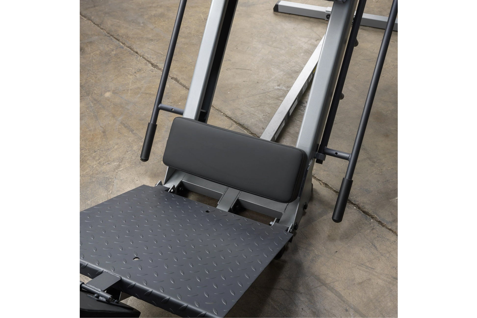 Body-Solid leg press and hack squat machine with black textured platform, padded backrest, and silver and black metal frame o
