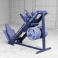 Body-Solid leg press and hack squat machine in navy blue with padded seat, foot platform, and weight plate storage on concret