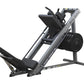 Body-Solid leg press and hack squat machine with gray frame, black padded seat and backrest, weight plate storage, on white b