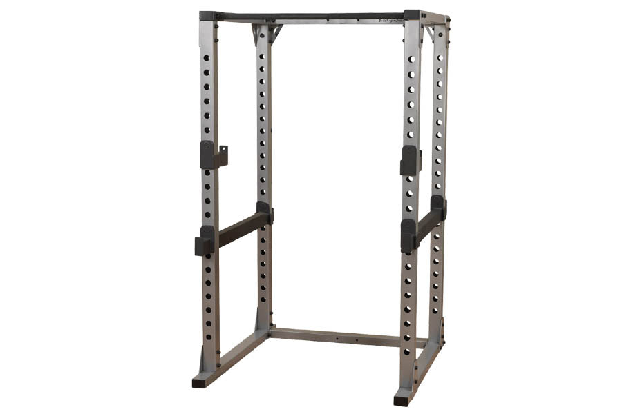Body-Solid Pro Power Rack with gray and black steel frame, adjustable safety bars, and perforated upright posts on white back