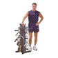 Man wearing navy sleeveless athletic tank top and shorts standing next to black vertical bike storage rack on white backgroun