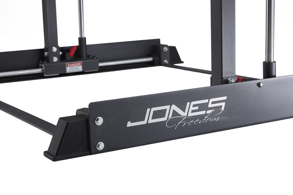 Black Jones Freedom Smith Machine with metal frame and safety bars on white background