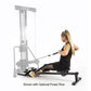 Woman using BodyCraft PFT Functional Trainer with optional power row attachment, seated on black bench with cable in extended