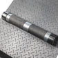 Chrome and gray dumbbell with textured grip on diamond plate gym flooring