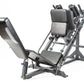 Black and gray leg press machine with padded seat, angled footplate, and adjustable back support on white background