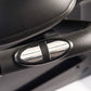 Black textured handle grip with chrome accents on exercise bike, close-up detail view