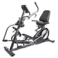 Black recumbent elliptical exercise bike with digital display, padded seat, and foot pedals on white background