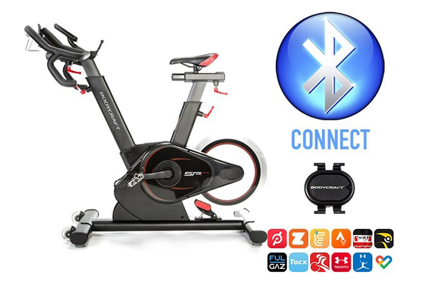 Black and gray BodyCraft SPR stationary exercise bike with red accents, adjustable seat and handlebars, shown with Bluetooth 