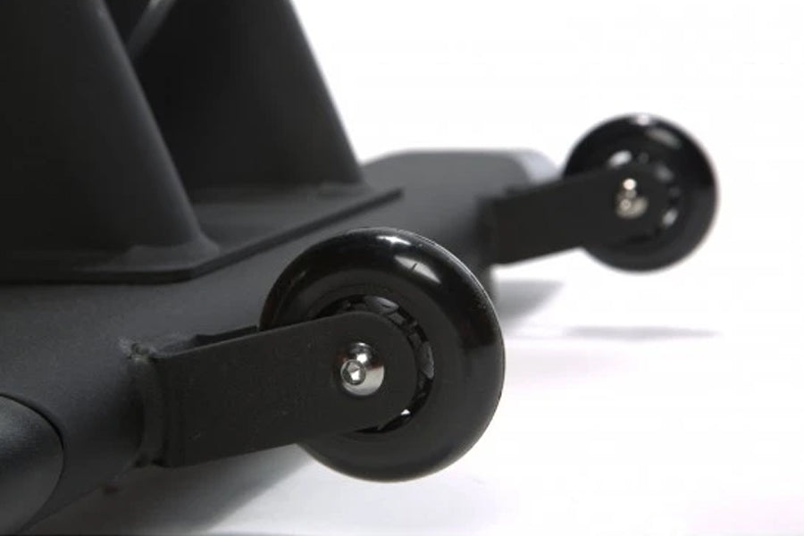 Black indoor training cycle with dual wheels and metal axles on white background