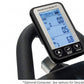 Bodycraft SPT-Mag stationary bike console with blue LCD display showing workout metrics, mounted on black handlebar, held by 