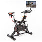 Black and red stationary indoor cycling bike with tablet mount displaying workout video, red handlebars, and padded seat on w