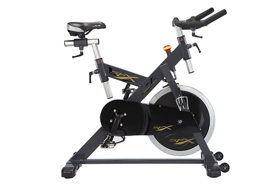 Black and silver stationary indoor exercise bike with large flywheel, padded seat, and handlebar grips on white background