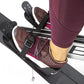 Burgundy leggings and brown perforated water shoes worn on rowing machine footplate, white socks visible