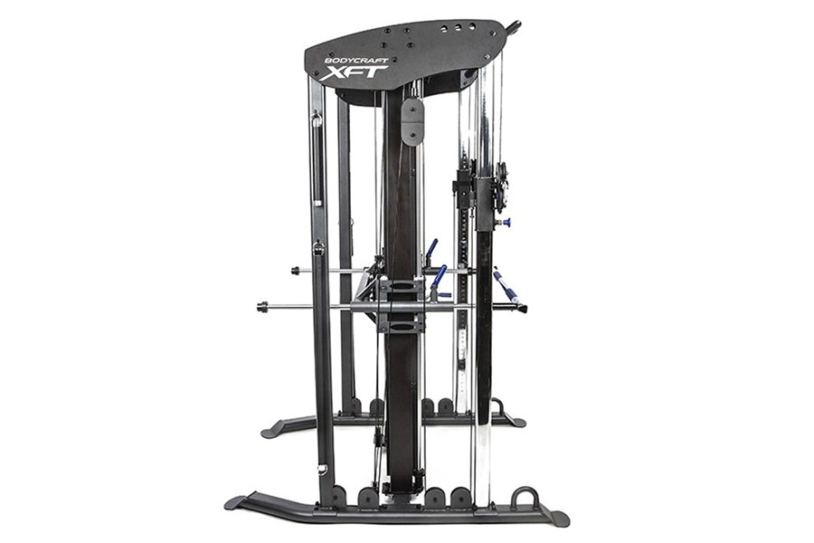 BodyCraft XFT functional trainer with dual cable towers, blue handles, and black steel frame on white background