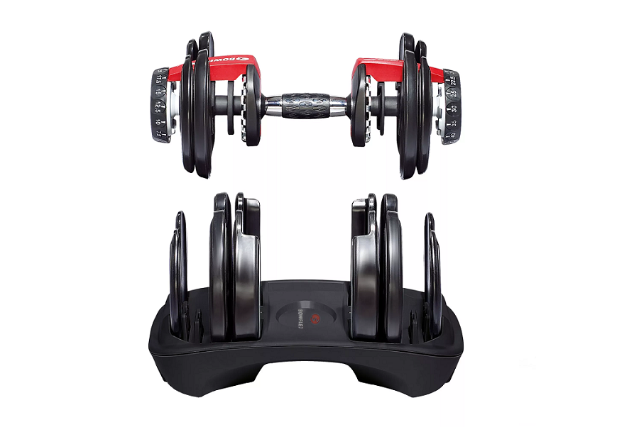 Pair of red and black adjustable dumbbells with numbered weight plates on stand, flat lay view
