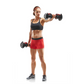 Athlete wearing black sports bra and red shorts holding adjustable dumbbells in workout stance on white background