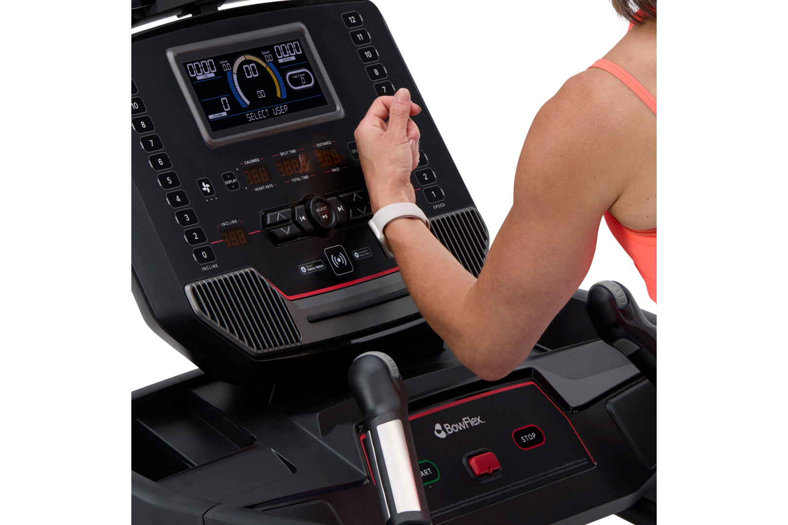 Person wearing coral sports bra using BowFlex T9 treadmill with digital display console and red accent trim, shown from side 