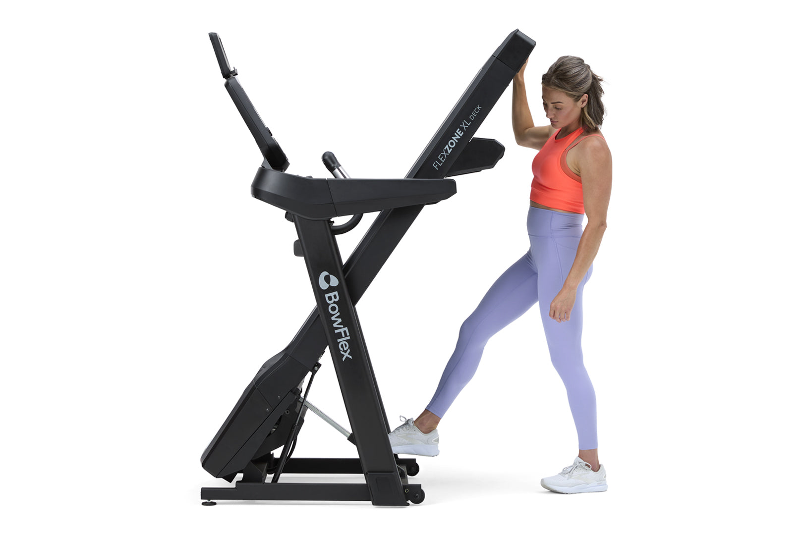 Black BowFlex T9 treadmill with digital display worn by woman in red tank top and lavender leggings on white background