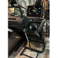 Black folding treadmill with digital display showing speed and power metrics, metal frame and black running belt in showroom 
