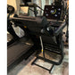 Black folding treadmill with digital display screen, cushioned running deck, and black frame on showroom floor
