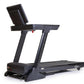 Black folding treadmill with digital display console, handrails, and running deck on white background