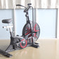 Black and red stationary air exercise bike with large fan wheel, digital display, and padded seat, on light background