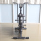 Black upright exercise bike with digital display console, padded seat, handlebars, and pedals with foot straps, front view on