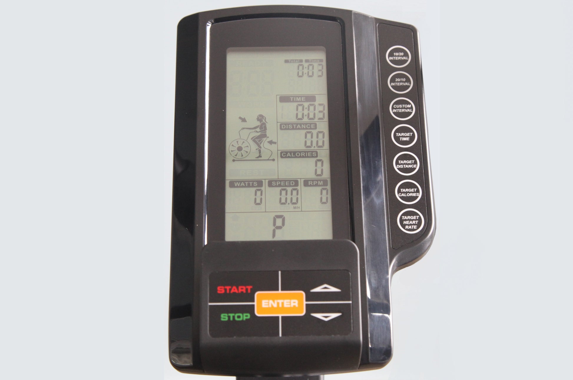 Black exercise bike console with LCD display showing time, distance, calories, watts, speed and RPM metrics, featuring orange