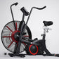 Black and red air exercise bike with large fan wheel, dual handlebars, and black seat on white background