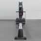 Black and white rowing machine with digital display console, handlebar, footrest pedals, and sliding seat on gray background
