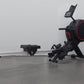 Black California Fitness AR5 rowing machine with red accents, digital display, and foot pedals on gray background