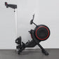 Black and red rowing machine with silver vertical rail, large circular flywheel with red accent ring, and adjustable footrest