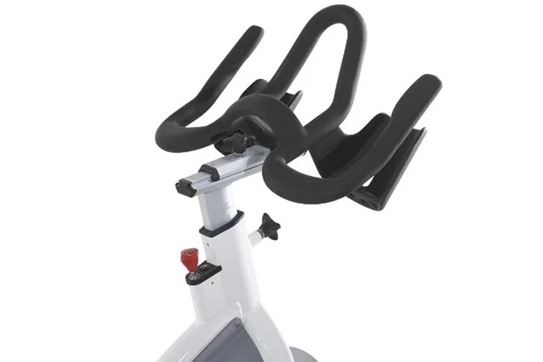 White and black stationary indoor exercise bike with curved black handlebars and red resistance dial on white background