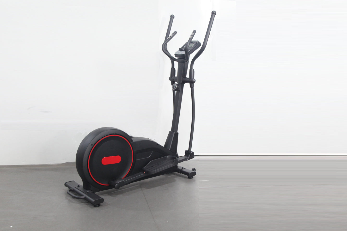 Black and red elliptical cross-trainer machine with curved handles and illuminated wheel accent, on gray floor