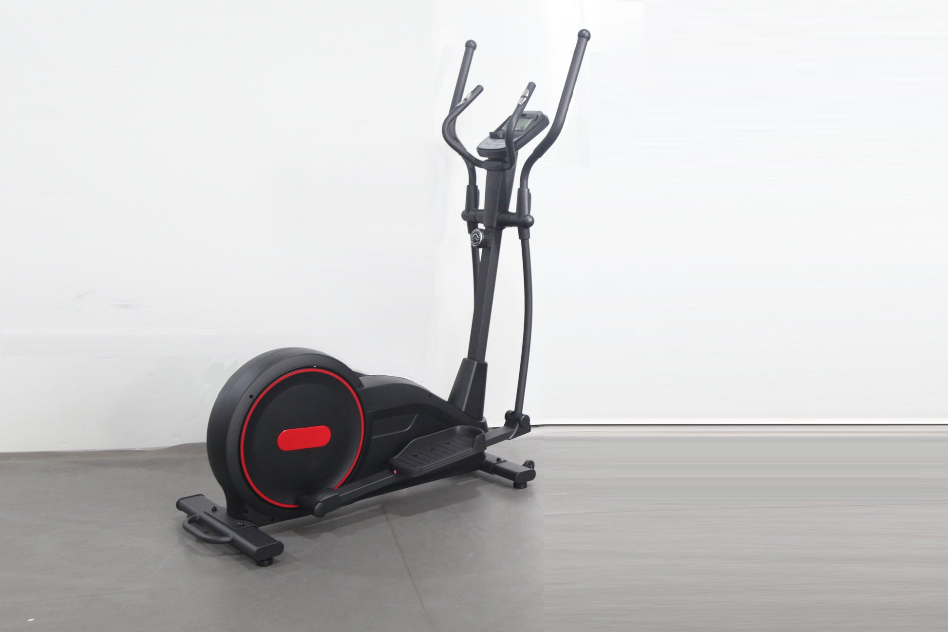 Black and red elliptical cross-trainer machine with curved handles and illuminated wheel accent, on gray floor