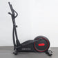 Black California Fitness elliptical cross-trainer with red accent wheel and dual handlebars on gray floor