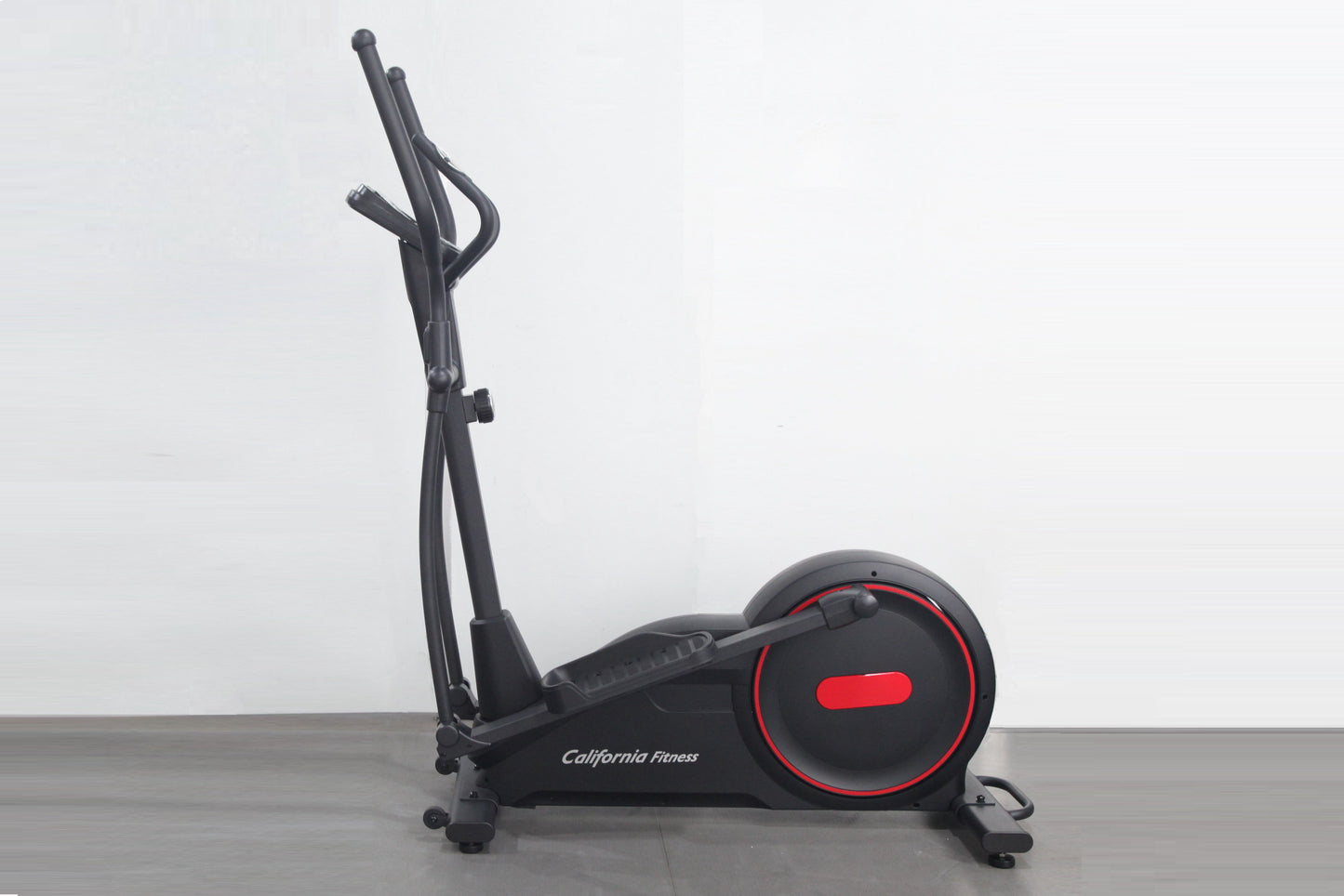 Black California Fitness elliptical cross-trainer with red accent wheel and dual handlebars on gray floor