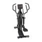 Black elliptical machine with digital display console, dual handles, and foot pedals on white background