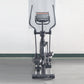 Black elliptical machine with digital display console, dual handles, and wide pedal base on white background, front view