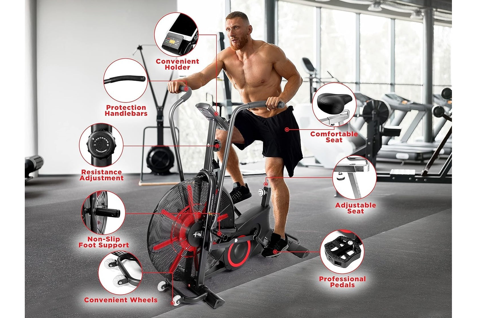 Man using black and red stationary air bike in gym with labeled features including resistance adjustment, comfortable seat, a
