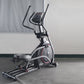 Black and silver elliptical machine with red accents and digital display on concrete floor