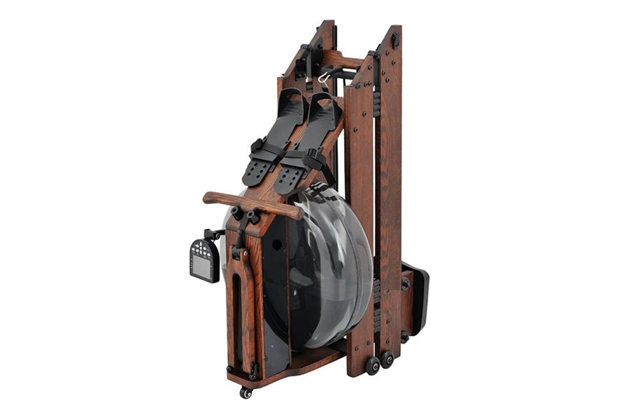 Folding water rowing machine with dark wood frame, black straps, gray water tank, and foot pedals on white background