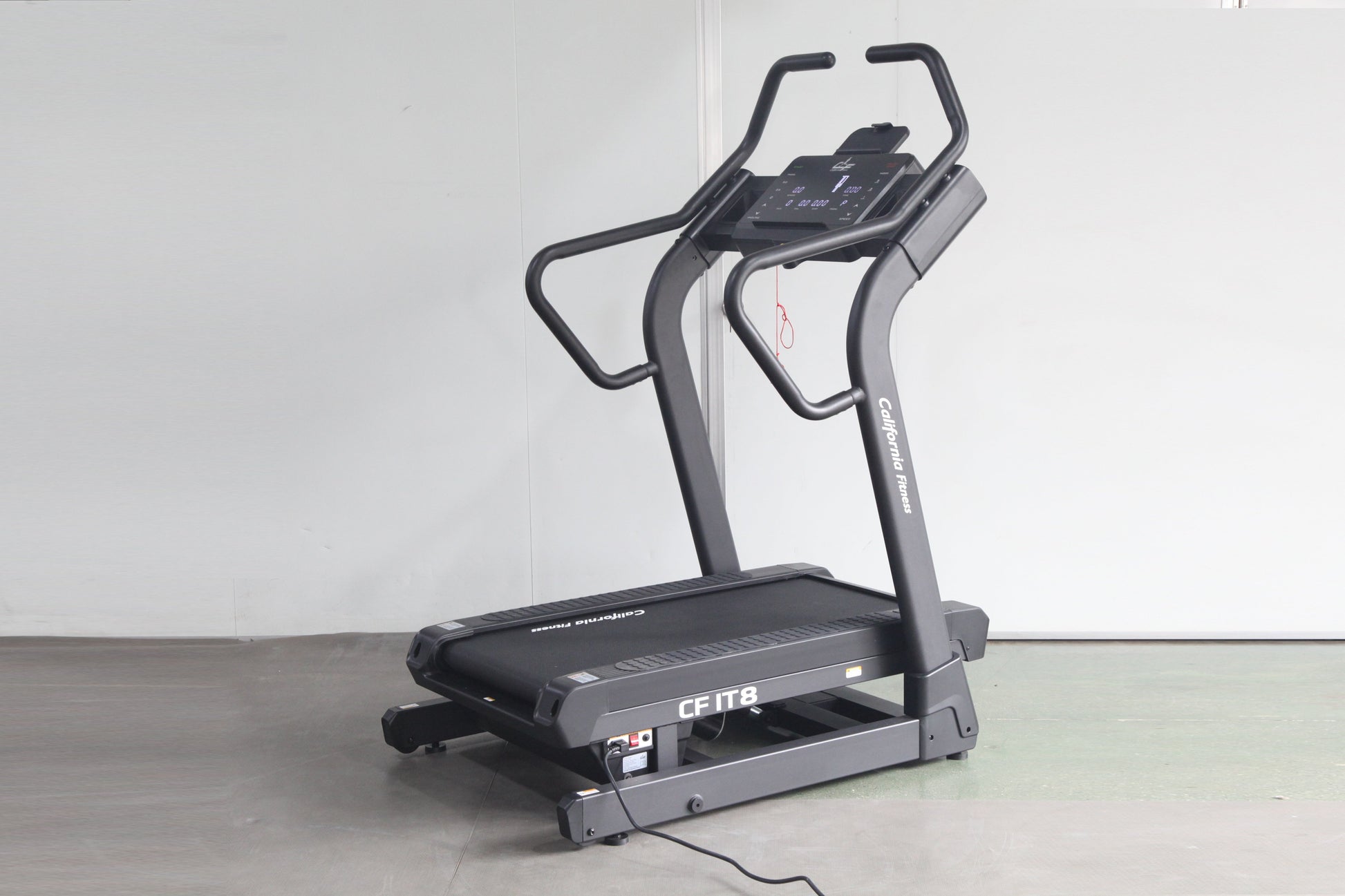 Black California Fitness IT8 incline trainer treadmill with digital display console and curved handles on white background